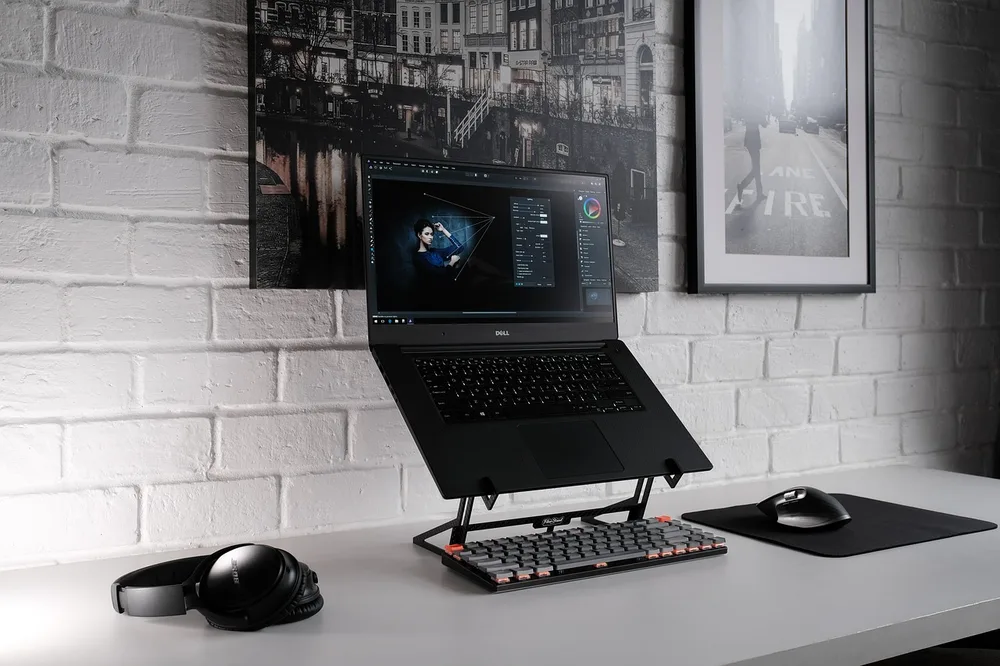 Cables bundled with reusable velcro ties behind a desk