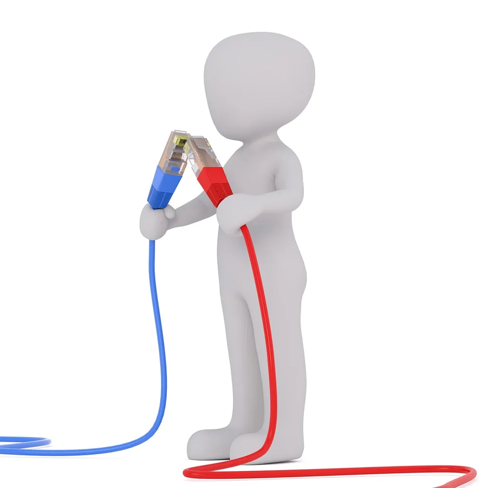 Plugs in a power strip tagged with small white labels