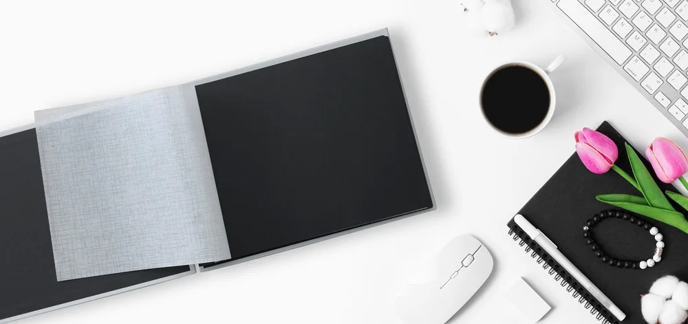 A cream keyboard, white mouse and sage desk mat on a gaming desk