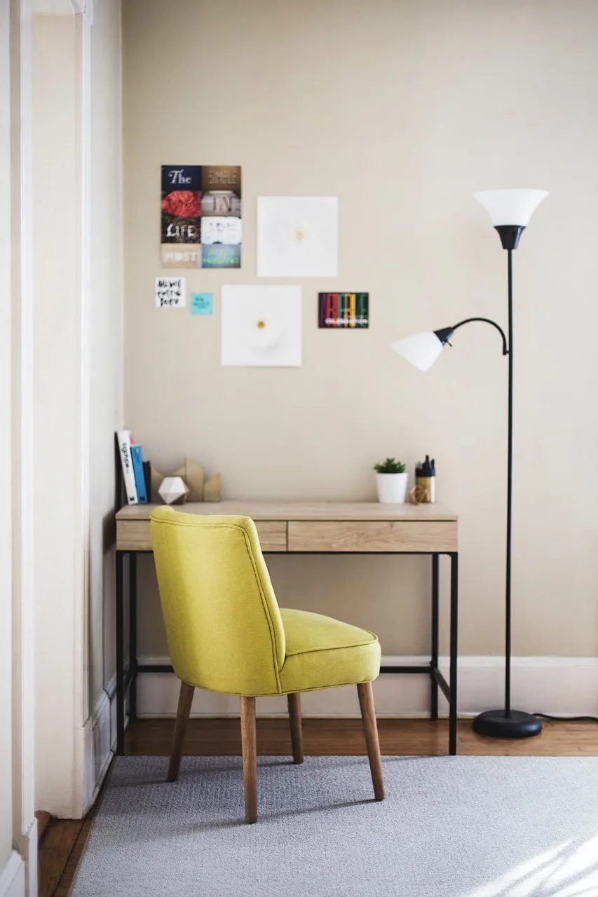 Warm fairy lights draped along a shelf above a gaming desk